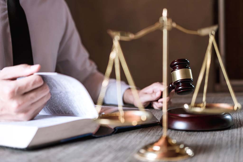 lawyer with gavel looking over paperwork