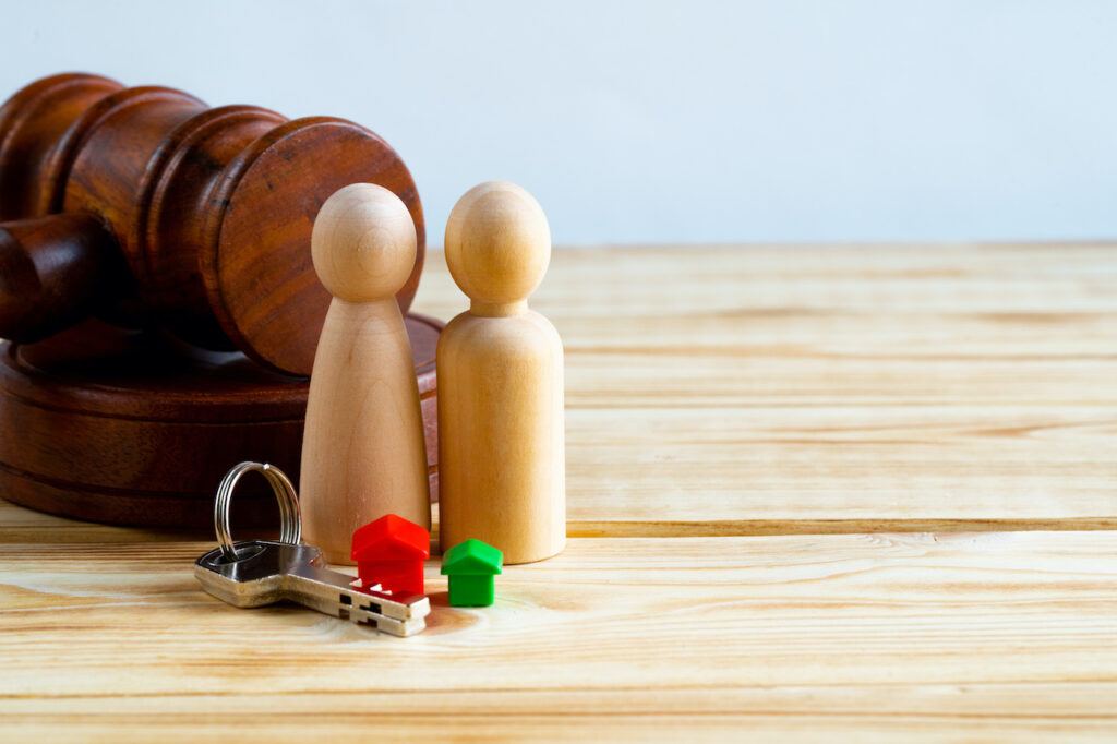 dividing assets in a divorce with gavel and wooden people figurines